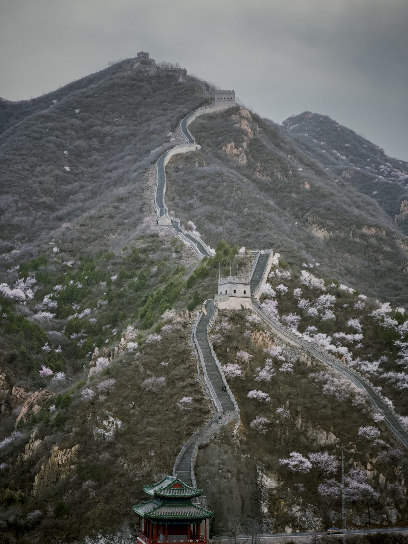 The Great Wall of China winding along forested mountain ridges