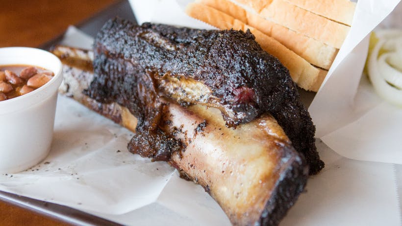 Smoked brisket with a side of toast and beans.