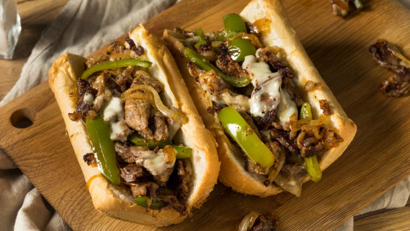 Philly Cheesesteak on a cutting board.
