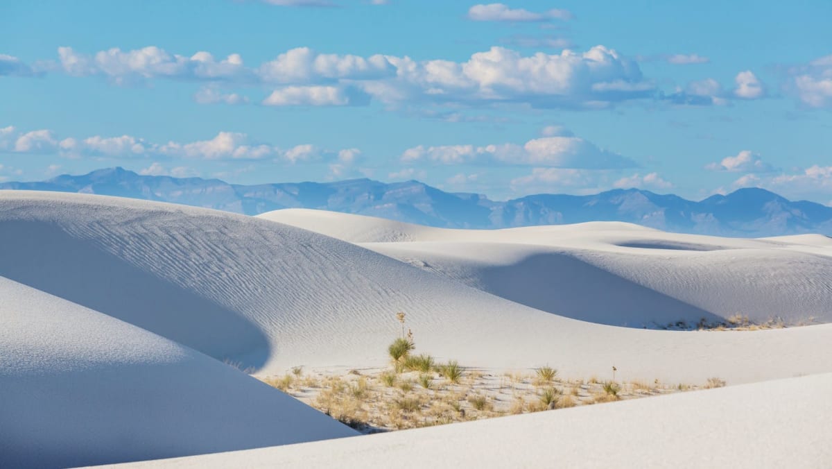 Perfectly white sand dunes in front of the mountains in New Mexico.