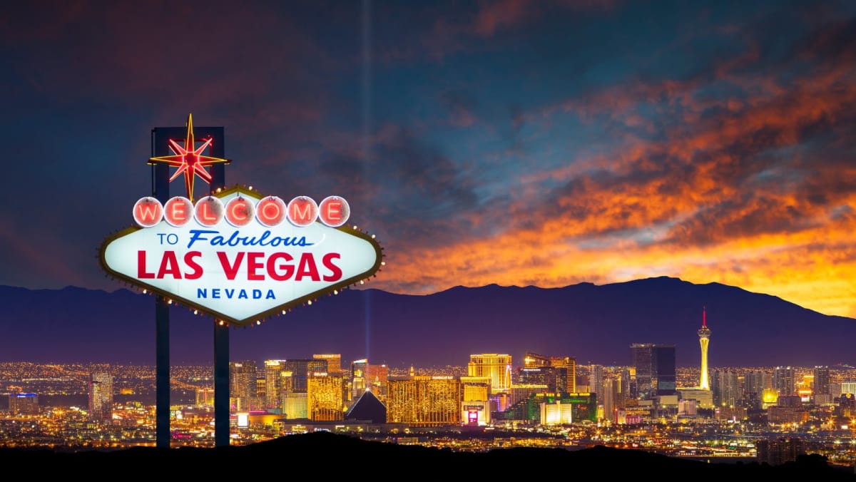 The Las Vegas Sign infront of the city's skyline.