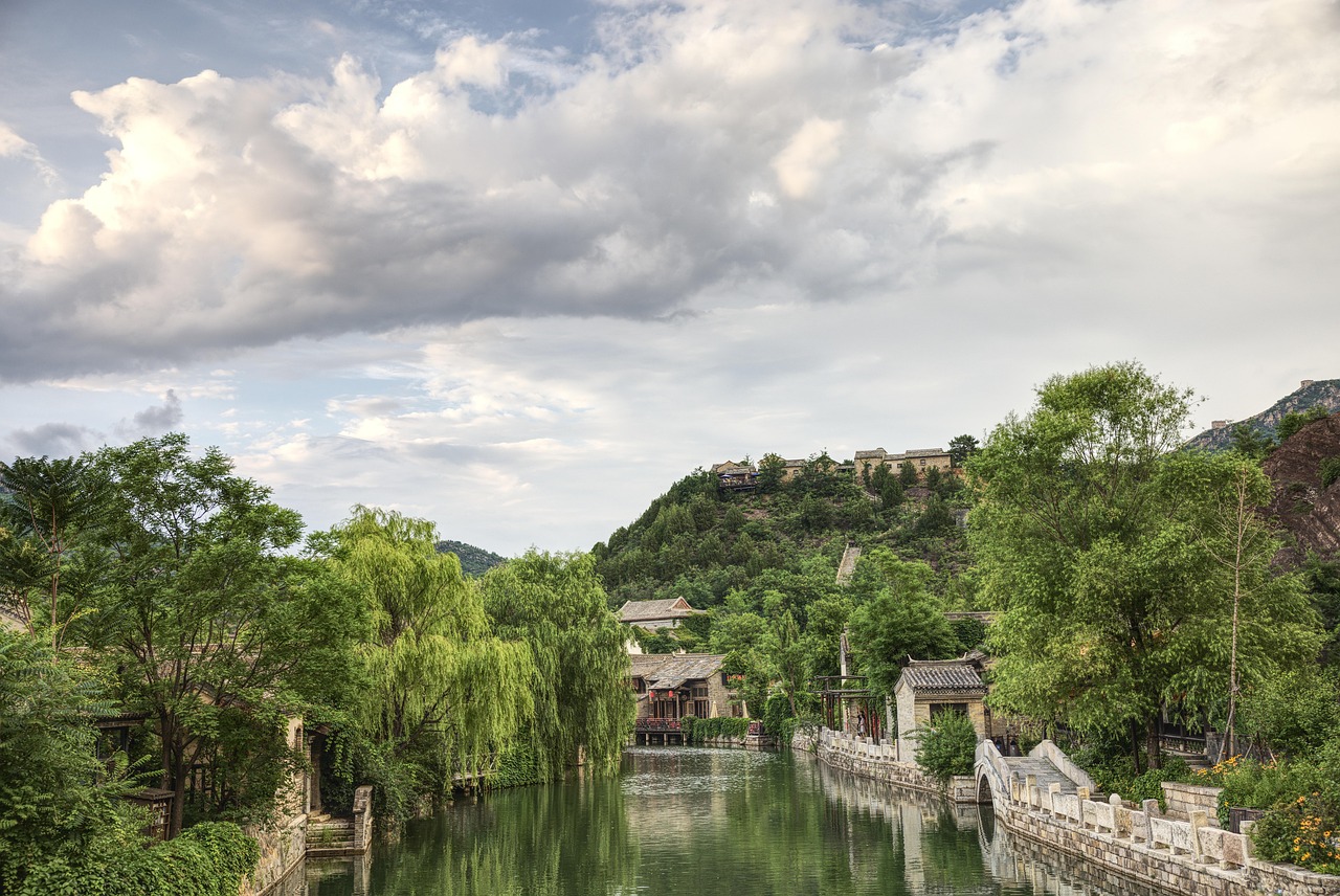 A small-town Chinese factory, with workers in the background and a cityscape in the distance, highlighting the resilience and adaptability of local manufacturing.