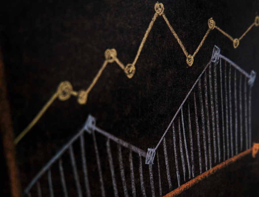 A chalk drawing on a blackboard of a line and a row of bars climbing from left to right
