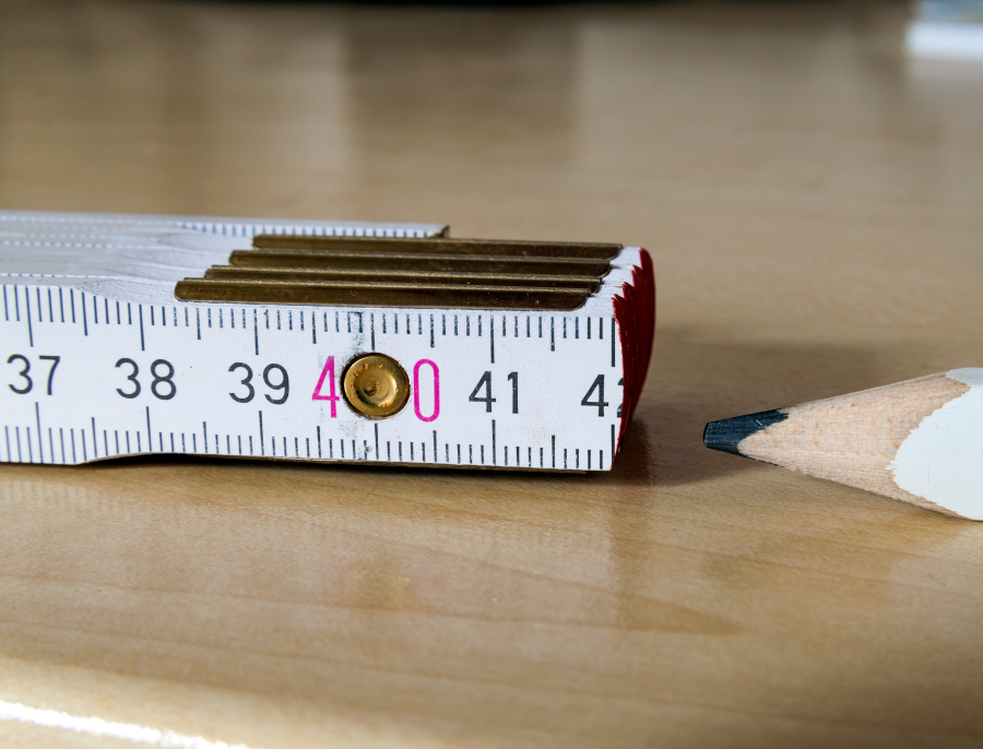 A folding carpenter's rule photographed close up with the number forty picked out in colour, a carpenter's pencil lying beside it