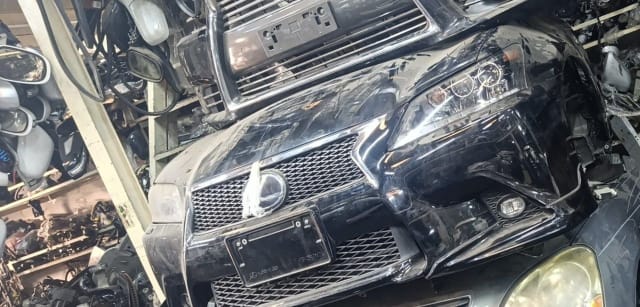 Black Lexus GS sedan front cut — spindle grille, bumper, headlight and fog lights, Sharjah market