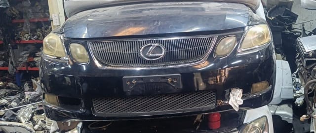 Black Lexus GS sedan front cut — bumper, chrome grille, emblem and headlights, Sharjah market