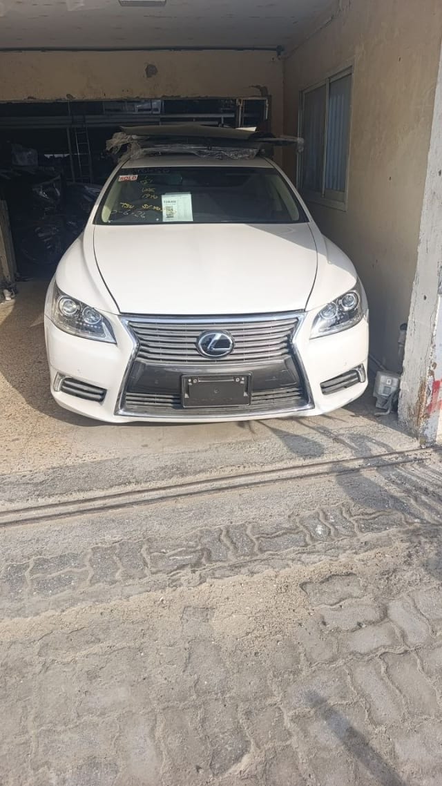 White Lexus LS460 sedan front — bumper, spindle grille and headlights, Sharjah market