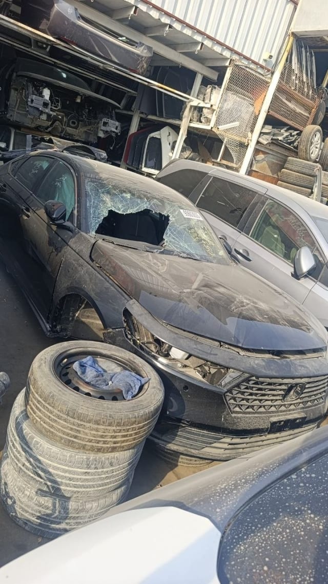 Dark grey Honda Accord sedan car for parts with damaged front bumper, grille and shattered windshield, Sharjah market