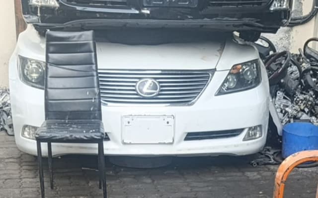 White Lexus LS460 sedan front cut — bumper, chrome grille and headlights, Sharjah market