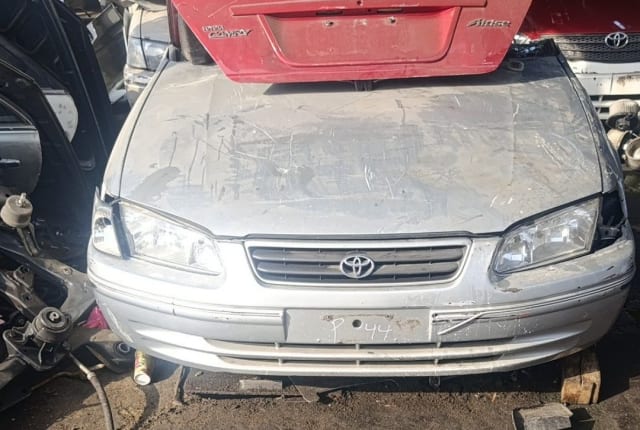 Silver Toyota Camry sedan front halfcut — hood, bumper, grille and headlights, Sharjah market