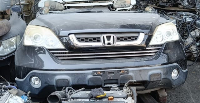 Black Honda CR-V SUV front halfcut — hood, chrome grille, headlights and bumper, Sharjah market