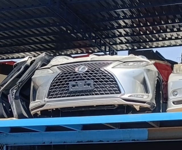 White Lexus RX SUV front cut — spindle grille, front bumper and hood, Sharjah market