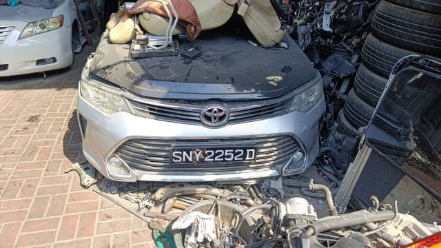 Silver Toyota Camry sedan front halfcut — grille, headlights, hood and bumper, Sharjah market