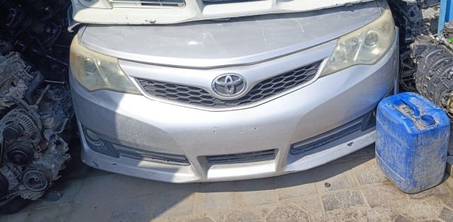 Silver Toyota Camry sedan front cut — bumper, grille and headlights, Sharjah market