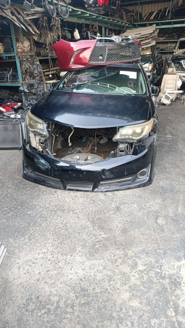 Black Toyota Camry sedan front halfcut — hood, bumper, grille and headlights, Sharjah market
