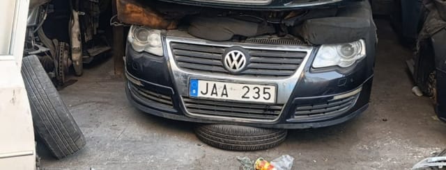 Dark grey Volkswagen Passat sedan front halfcut — bumper, grille and headlights, Sharjah market