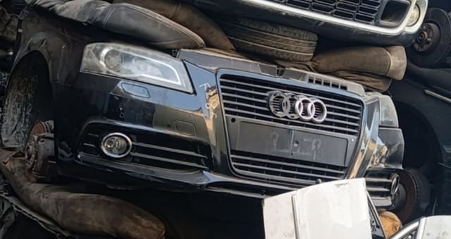 Black Audi A4 sedan front cut — bumper, grille and headlight with fog light, Sharjah market