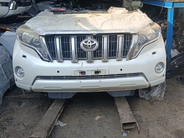 White Toyota Land Cruiser Prado front cut — bumper, chrome grille and headlights, Sharjah market