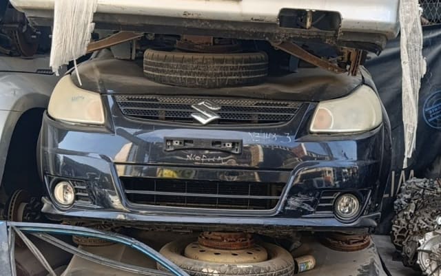 Black Suzuki SX4 hatchback front halfcut — bumper, grille, headlights and fog lights, Sharjah market