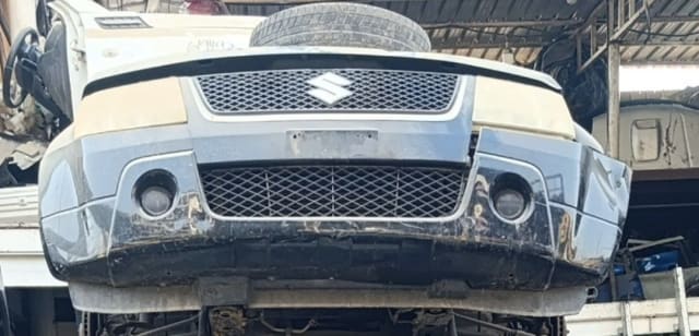 Black and beige Suzuki Grand Vitara SUV front cut — bumper, grille and fog lamp housings, Sharjah market