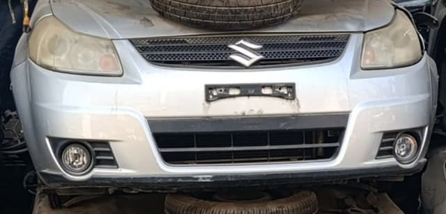 Silver Suzuki SX4 hatchback front cut — bumper, grille, headlights and fog lights, Sharjah market