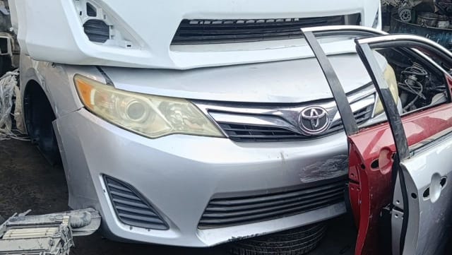 Silver Toyota Camry sedan front cut — bumper, grille, headlights and hood, Sharjah market