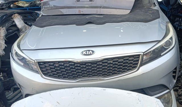 Silver Kia Forte sedan front halfcut — hood, grille, headlights and front bumper, Sharjah market