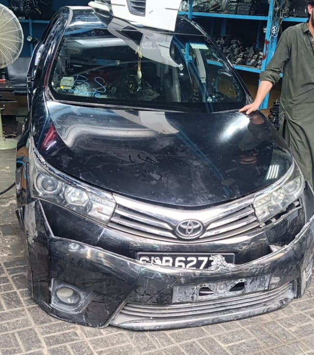 Black Toyota Corolla sedan front cut — hood, bumper, grille and headlights, Sharjah market