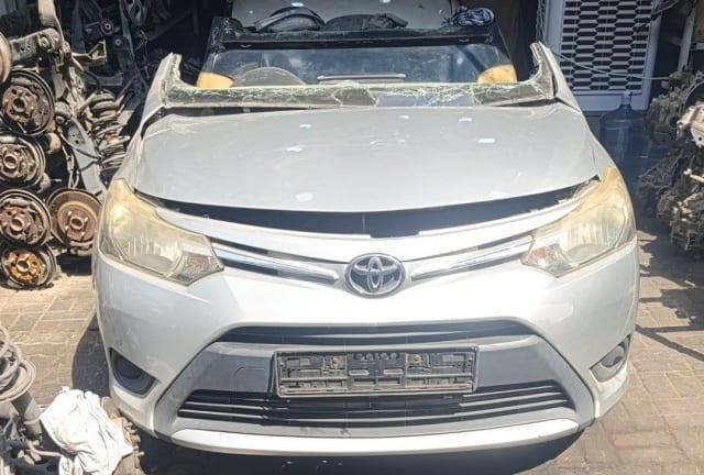 Silver Toyota Yaris sedan front halfcut — bumper, grille, headlights and hood, Sharjah market