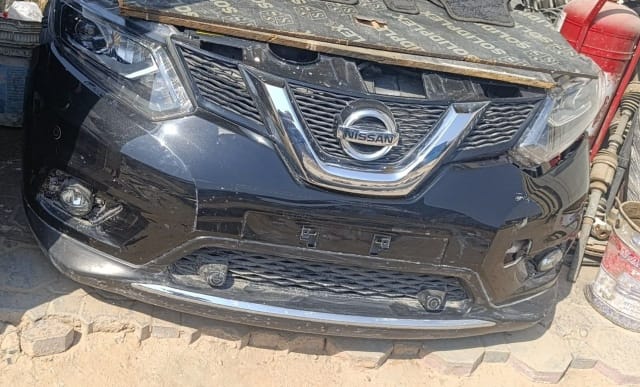 Black Nissan X-Trail front cut — grille, headlight and front bumper, Sharjah market
