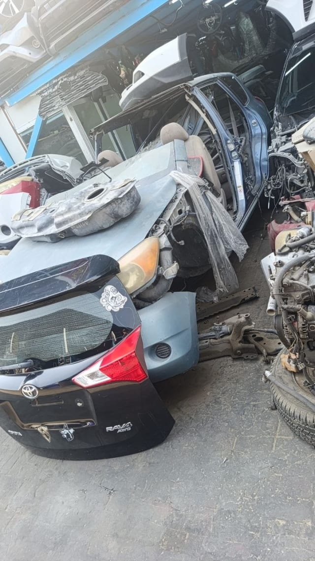 Toyota RAV4 SUV halfcut — tailgate, tail light and rear bumper among dismantled parts, Sharjah market