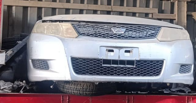 Silver Toyota Corolla Fielder front cut — bumper, grille and headlight, Sharjah market