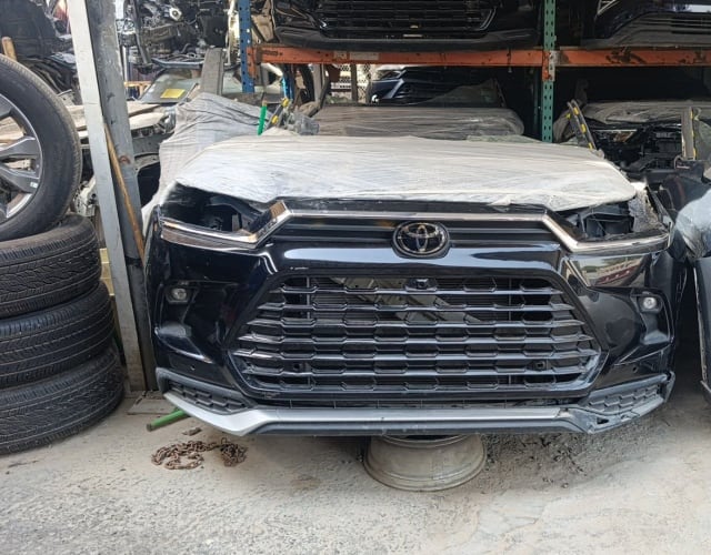 Black Toyota Highlander SUV front cut — bumper, mesh grille and Toyota emblem, Sharjah market