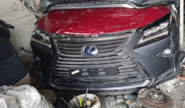 Dark grey Lexus RX SUV front halfcut — grille, headlights and red hood, Sharjah market