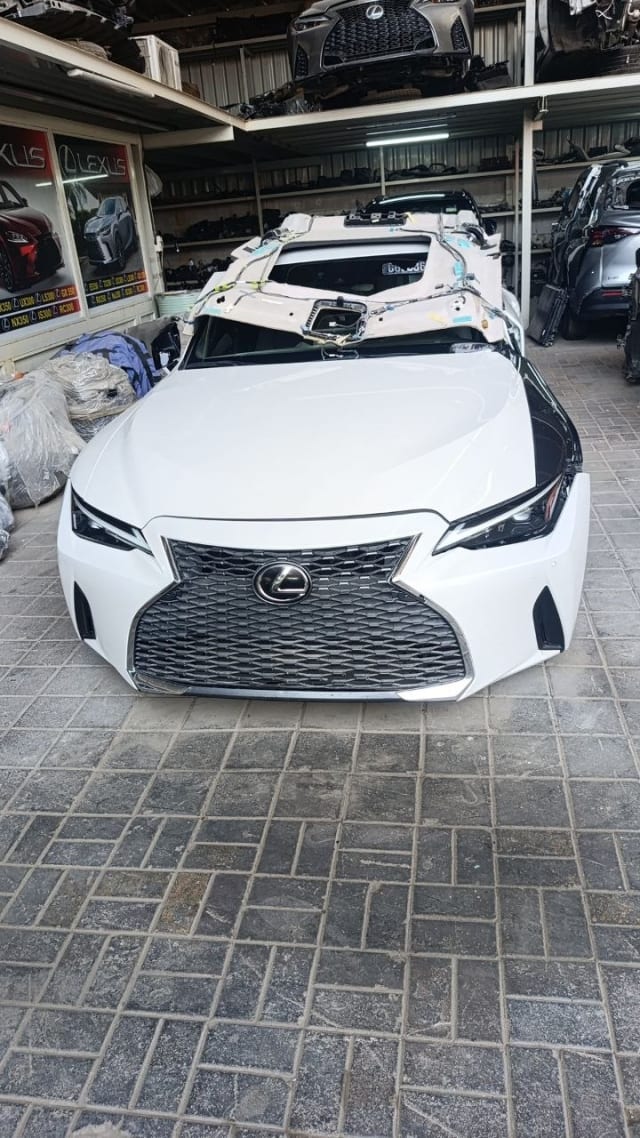 White Lexus IS front halfcut — spindle grille, headlights, bumper and hood, Sharjah market