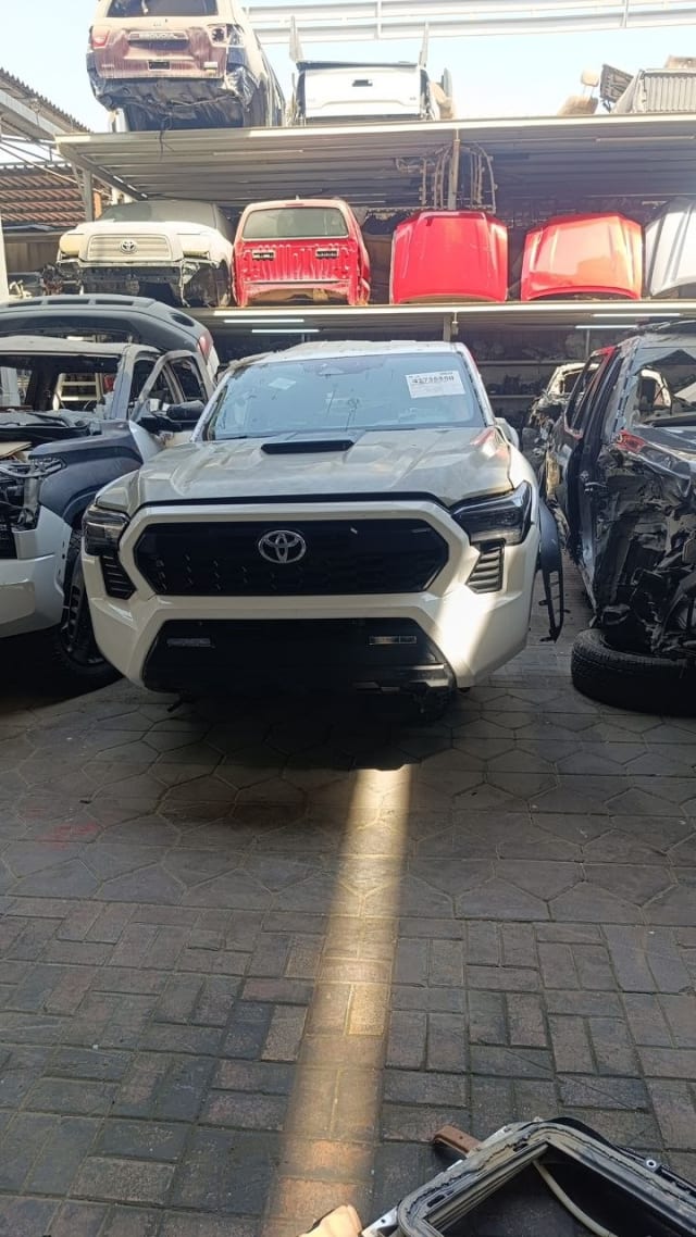 White Toyota Tacoma front halfcut — bumper, grille, hood and headlights, Sharjah market