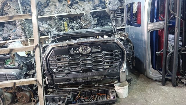 Dark grey Toyota Tundra pickup front halfcut — TRD grille, front bumper and engine bay, Sharjah market
