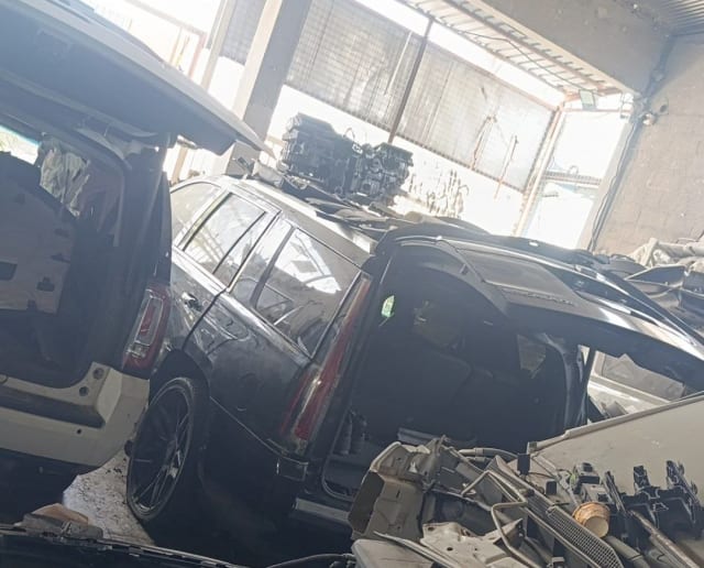 Black Cadillac Escalade SUV halfcut — rear body, tailgate, alloy wheels and taillight, Sharjah market