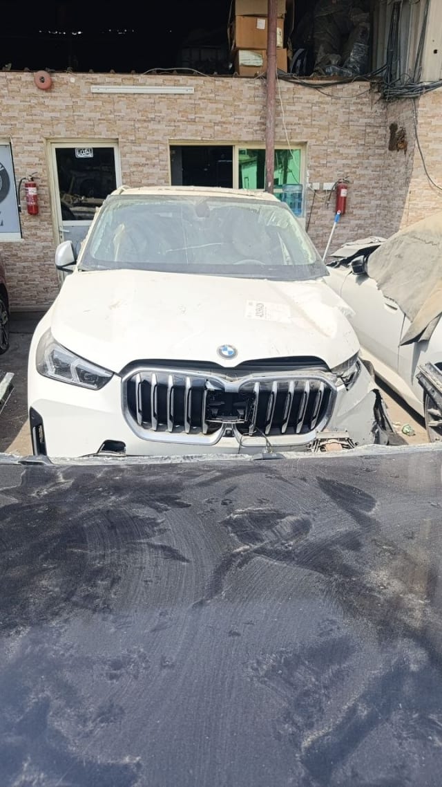 White BMW X1 SUV front halfcut — kidney grille, headlights, hood and bumper, Sharjah market