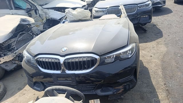 Black BMW 3-Series sedan front halfcut — hood, kidney grille and headlight, Sharjah market