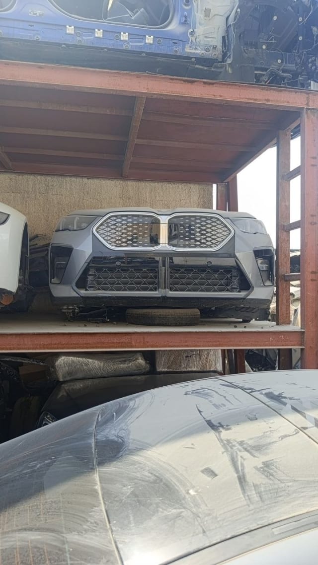 Silver-grey BMW X6 front cut on rack — bumper, kidney grille and headlights, Sharjah market