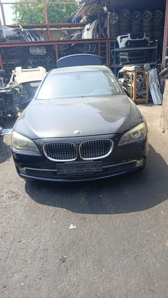 Black BMW 7-Series sedan front cut — hood, kidney grille, headlights and bumper, Sharjah market