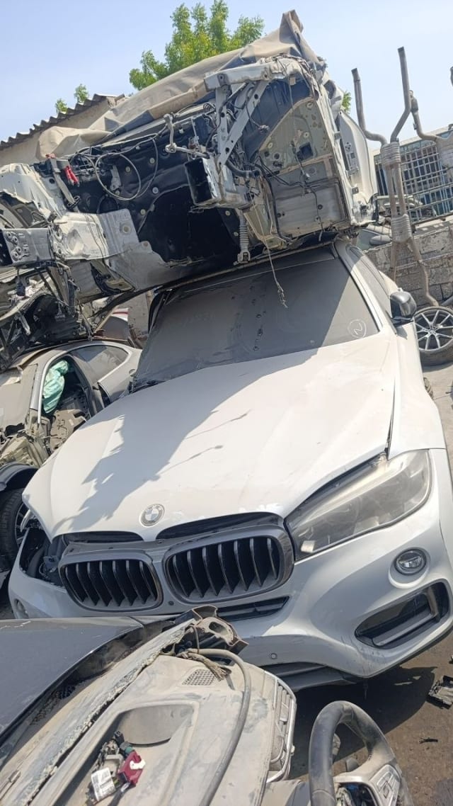 Silver BMW X5 SUV front halfcut — kidney grille, hood, bumper and headlight, Sharjah market