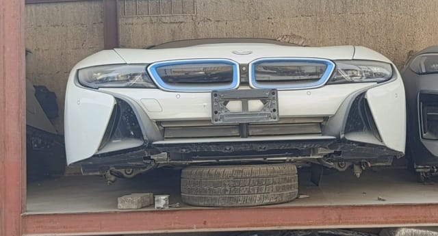 White BMW i8 coupe front halfcut — bumper, blue-accent grille and headlights, Sharjah market