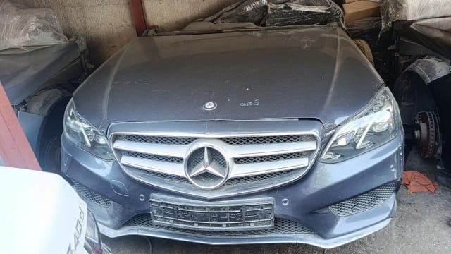 Dark grey Mercedes-Benz E-Class sedan front cut — hood, grille, bumper and headlights, Sharjah market