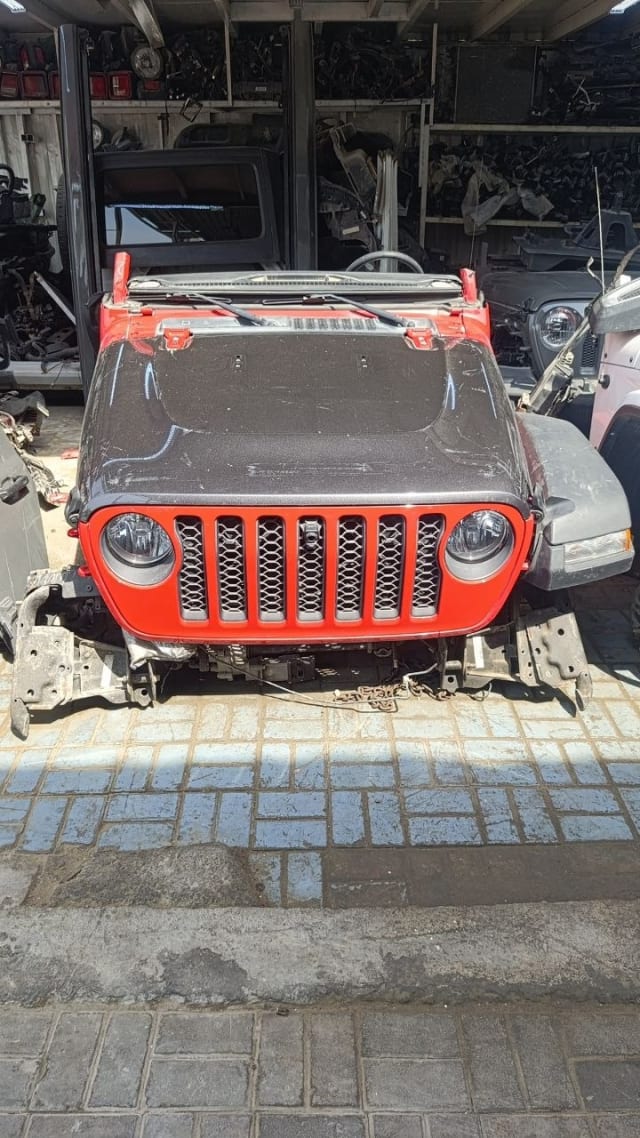 Dark grey Jeep Wrangler front halfcut with red grille, headlights and hood, Sharjah market