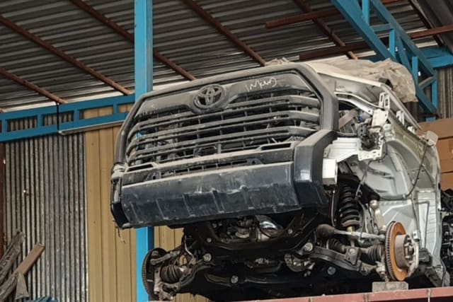 Silver Toyota Tundra pickup front halfcut — bumper, grille and exposed front suspension, Sharjah market
