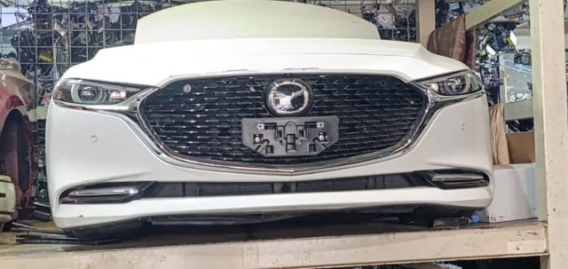 White Mazda Mazda3 front cut — bumper, chrome grille, headlights and hood, Sharjah market