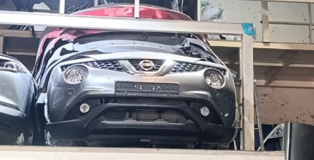 Silver-grey Nissan Juke SUV front halfcut — bumper, grille, headlights and hood, Sharjah market