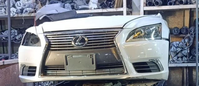 White Lexus LS460 front cut — bumper, chrome spindle grille and headlights, Sharjah market